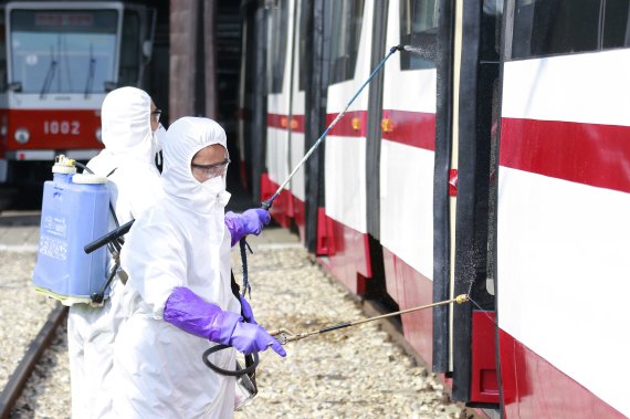 Members from an emergency anti-epidemic headquarters in Mangyongdae District, disinfect a tramcar of Songsan Tram Station to prevent new coronavirus infection in Pyongyang, North Korea Wednesday, Feb. 26, 2020. Uncertainly remained over how best to stem the spread of the illness. (AP Photo/Jon Chol 