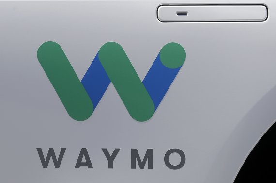 FILE - In this May 8, 2018, file photo, a Waymo logo is displayed on the door of a car at the Google I/O conference in Mountain View, Calif. Google's former autonomous vehicle project is borrowing money on its own for the first time. Waymo, which is developing autonomous ride-hailing vehicles and se