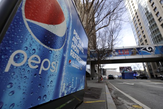 FILE - In this Jan. 30, 2019, file photo, an advertisement for Pepsi is shown downtown for the NFL Super Bowl 53 football game in Atlanta. PepsiCo says it's buying energy drink maker Rockstar Energy Beverages for $3.85 billion. PepsiCo and Coca-Cola have moved aggressively in their pursuit of consum