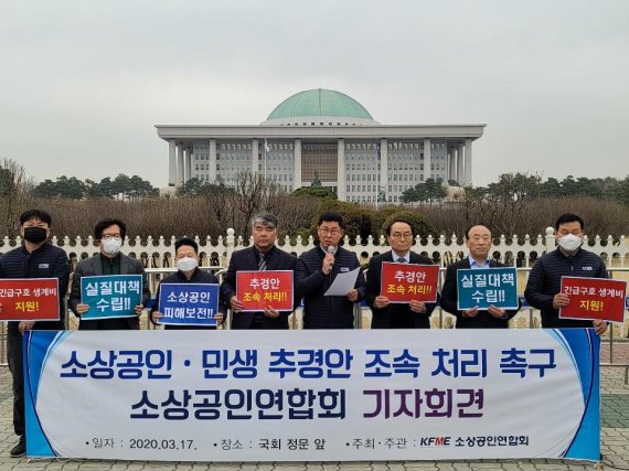 김임용 소상공인연합회장 직무대행(왼쪽 다섯번째)을 비롯한 소상공인들이 17일 국회 앞에서 기자회견을 열고 추경안 조속 처리를 촉구하고 있다.