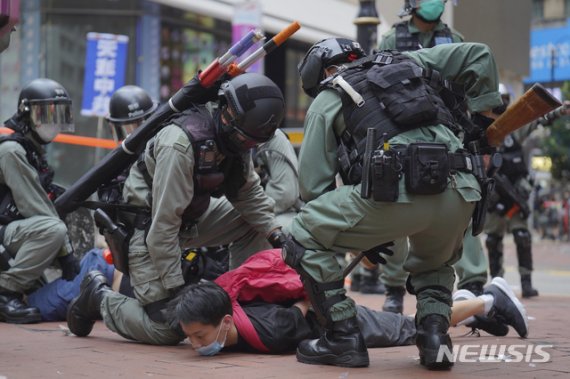 [코즈웨이베이=AP/뉴시스]홍콩 코즈웨이베이에서 24일 중국의 국가보안법 제정에 반대하는 시위에 참가한 사람이 경찰에 체포되고 있다.