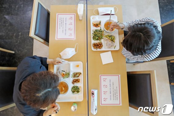 사회적 거리두기에서 생활 속 거리두기로 전환된 6일 오전 경기도 수원시청 구내식당에서 직원들이 신종 코로나바이러스 감염증(코로나19)을 예방하기 위해 칸막이 사이로 점심 먹고 있다. 2020.5.6/뉴스1 © News1 조태형 기자