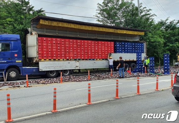 10일 오전 11시13분쯤 광주 북구 연제동 한 도로에서 25톤 화물차에서 맥주 500여박스가 쏟아져 도로에 맥주병 수천개가 깨져있다.(독자제공)2020.7.10/뉴스1 © News1