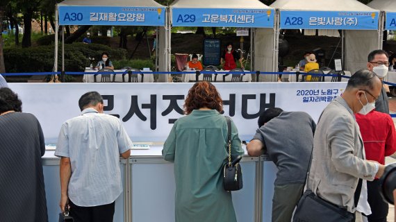 2020 노원구 일자리박람회가 15일 서울 중계근린공원에서 열려 구직자들이 이력서를 작성하고 있다. 이번 박람회에는 57개 업체가 참여했다. 사진=서동일 기자