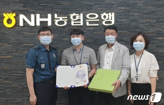 NH농협 동청주지점은 직원 구자일씨(왼쪽 두번째)가 고객의 보이스피싱 피해를 막아 상당경찰서로부터 감사장을 받았다고 밝혔다.(농협 제공)© 뉴스1