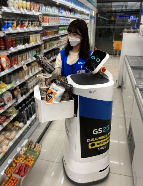 GS25 직원이 주문 받은 상품을 배달로봇 '딜리오'에 담고 있다.