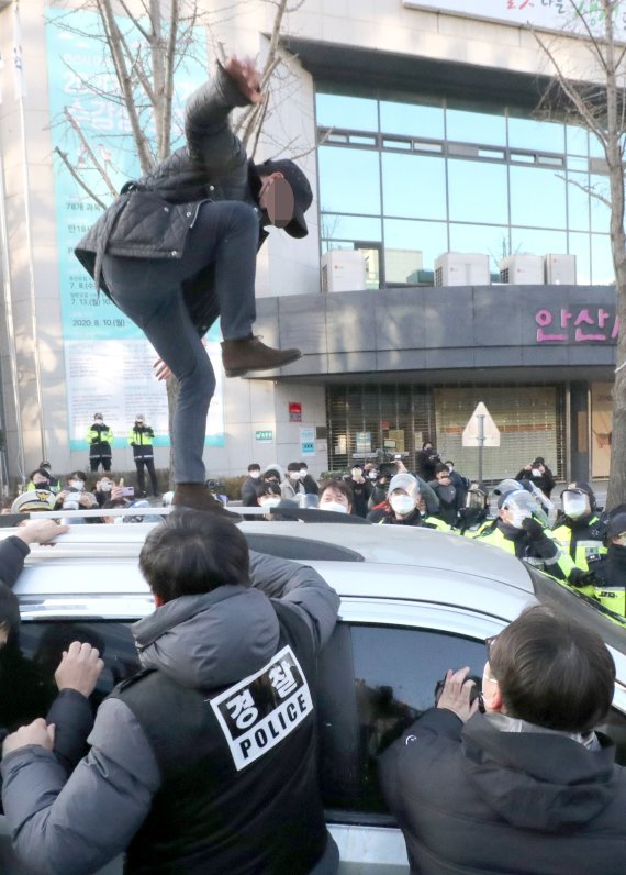 아동 성범죄자 조두순 출소일인 지난 12일 오전 일부 시민들이 경기도 안산준법지원센터를 나서 집으로 향하는 호송차량을 막고 있다. 뉴시스