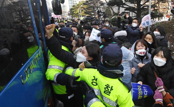 16개월 된 입양 딸 정인이를 학대해 숨지게 한 혐의를 받는 양부모의 첫 재판이 13일 서울 신월로 서울남부지법에서 열렸다. 남부지법 앞에서 정인이 양모가 탄 호송 차량이 나오자 시민들이 몰려들어 '살인죄 처벌'을 외치며 분노하고 있다. 사진=김범석 기자