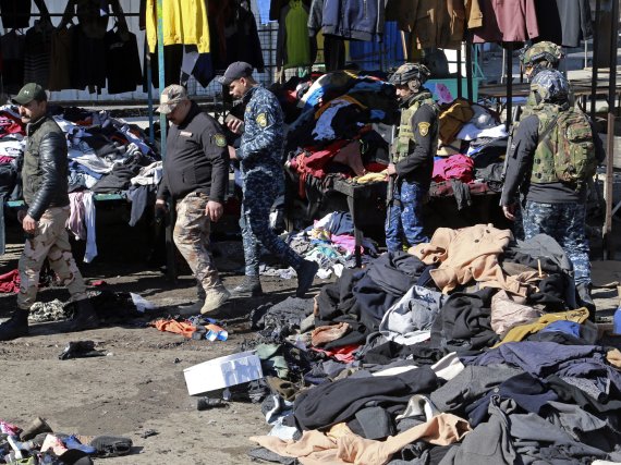 Security forces work at the site of a deadly bomb attack in Baghdad, Iraq, Thursday, Jan. 21, 2021. Iraq's military said twin suicide bombings at the Bab al-Sharqi commercial area in central Baghdad Thursday ripped through the busy market killing over two dozen and wounding over 70, with some in ser