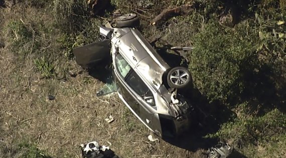 미국 캘리포니아주 로스앤젤레스 남쪽 도로에서 23일(현지시간) 미국 프로 골퍼 타이거 우즈가 탑승했던 차량이 뒤집혀 있다.AP뉴시스