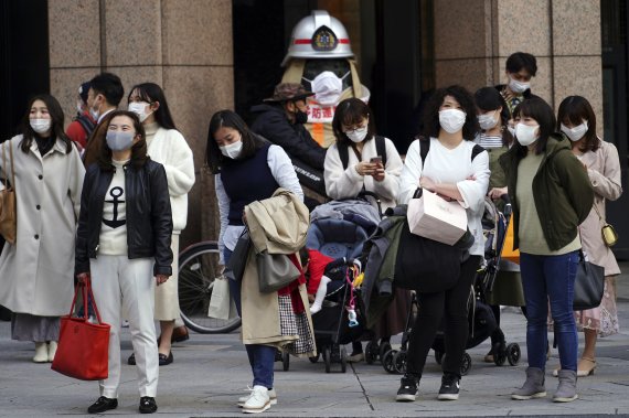 3월 초 도쿄 거리 풍경. 마스크를 쓴 사람들이 횡단보도 앞에서 신호를 기다리고 있다. AP뉴시스