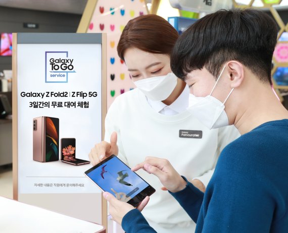 서울 강남구 삼성 디지털프라자 도곡점을 찾은 소비자들이 갤럭시 팬큐레이터에게 새로워진 '갤럭시 To Go 서비스'를 안내 받고 있다. 삼성전자 제공