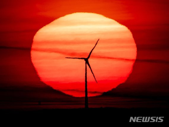 최근 미국 텍사스에서 한파로 인해 풍력발전이 중단되면서 신재생에너지 투자 관련 '그린 버블' 논란이 확산되고 있다. 사진는 독일 프랑크푸르트에서 풍력 발전용 터빈 뒤로 해가 떠오르고 있는 모습. /사진=뉴시스