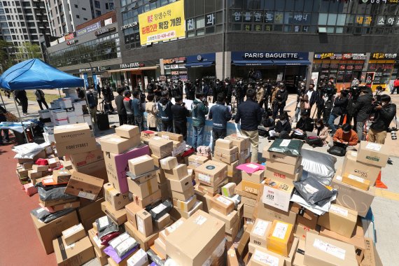 전국택배노동조합 조합원들이 지난 14일 서울 강동구 고덕동의 한 아파트단지 입구에 택배물품을 내린 후 아파트 단지 앞 배송 실시 기자회견을 열고 있다. 뉴시스 제공