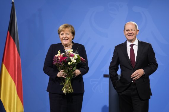 8일(현지시간) 독일 베를린 총리관저에서 새로 취임한 올라프 숄츠 독일 총리(오른쪽)가 앙겔라 메르켈 전 총리와 함께 사진을 찍고 있다.AP뉴시스