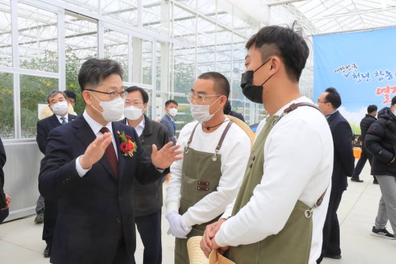 김현수 농식품부 장관이 15일 경북 상주시 스마트팜 혁신밸리 준공식에 참석해 청년농과 이야기를 나누고 있다.