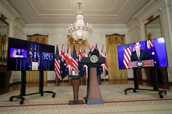 조 바이든 미국 대통령이 지난 9월 15일(현지시간) 미국 워싱턴 백악관 이스트룸에서 스콧 모리슨 호주 총리, 보리스 존슨 영국 총리와 함께 오커스(AUKUS) 파트너십 체결을 발표하고 있다. 세 나라는 호주에 핵추진잠수함 기술을 제공하는 것을 첫 번째 프로젝트로 추진한다고 밝혔다.