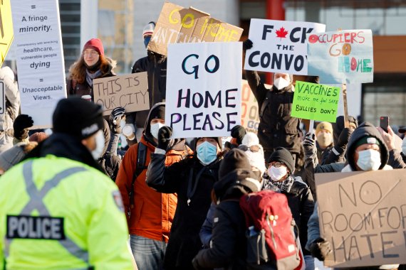 캐나다 오타와 시민들이 5일(현지시간) 트럭 시위자들에게 시위를 그만하고 집으로 돌아가라는 플래카드를 들고 있다.<div id='ad_body3' class='mbad_bottom' ></div> /사진=로이터뉴스1
