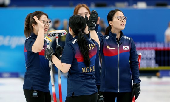 지난 12일 중국 베이징 내셔널 아쿠아틱 센터에서 열린 2022 베이징 동계올림픽 컬링 여자 한국과 러시아올림픽위원회(ROC)와의 경기에서 한국 팀 킴이 엔드를 마무리 지으며 하이파이브하고 있다. / 사진=뉴시스