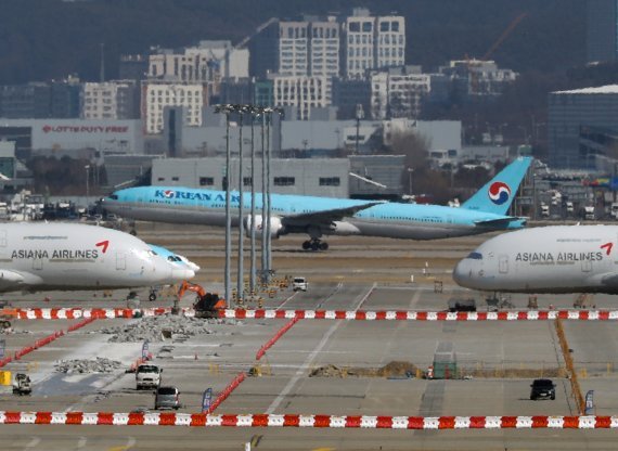 공정거래위원회가 22일 대한항공과 아시아나 항공의 합병에 대해 조건부 승인을 결정했다. 사진은 이날 인천국제공항에 대한항공과 아시아나 항공기가 함께 있는 모습. 사진=뉴스1