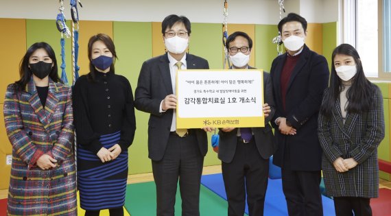 KB손해보험 경영전략본부장 조경희 상무(왼쪽 세번째)와 동현학교 하준석 교장(왼쪽 네번째)이 지난 25일 경기도 광주시 특수학교 동현학교에서 첫번째 감각통합치료실 개소식을 진행한 후 기념촬영을 하고 있다. KB손해보험 제공