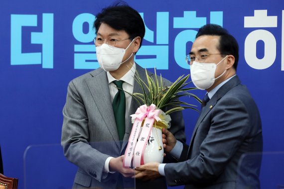 박홍근 더불어민주당 신임 원내대표가 25일 오전 서울 여의도 국회에서 장제원 대통령 당선인 비서실장로부터 윤 당선인의 축하 난과 메시지를 전달받고 있다. 2022.3.25/뉴스1 © News1 이동해 기자