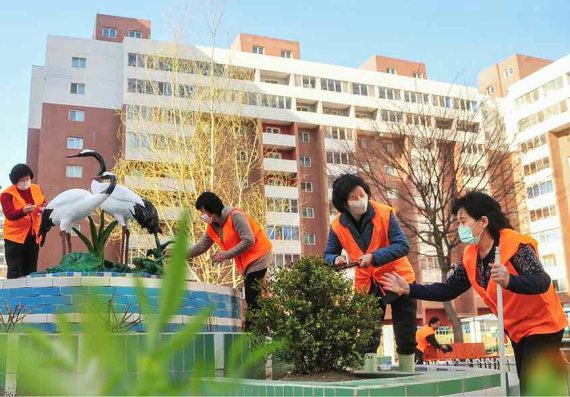 (평양 노동신문=뉴스1) ='태양절' 맞이 화단을 정리하는 북한 평양 중구역 서문동 주민들. [국내에서만 사용가능. 재배포 금지. DB 금지. For Use Only in the Republic of Korea. Redistribution Prohibited] rodongphoto@news1.kr