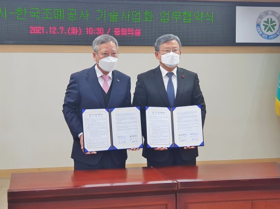 반장식 한국조폐공사 사장(왼쪽)이 5일 김명수 대전시 과학부시장과 무상기술이전 협약을 맺은 협약서를 들어보이고 있다.