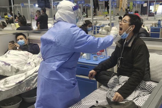 Residents get tested during their stay at a temporary hospital converted from the National Exhibition and Convention Center to quarantine COVID-positive people in Shanghai, China on April 18, 2022. Interviews with family members of people testing positive for COVID-19, a phone call with a government