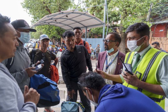 A team of climbers prepare to leave for rescue operations from the Tribhuvan International Airport in Kathmandu, Nepal, Sunday, May 29, 2022. A small airplane with 22 people on board flying on a popular tourist route was missing in Nepal’s mountains on Sunday, an official said. The Tara Airlines pla