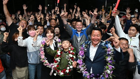 2일 오전 6·1 지방선거 전북 순창군수에 출마한 무소속 최영일 후보의 당선이 확실시 되자 최 후보(앞 오른쪽)가 성원해준 지지자들을 비롯해 가족인 부인 김주하 여사(앞 왼쪽), 아들 최온유 군(앞 가운데)과 함께 기뻐하고 있다. *재판매 및 DB 금지 /사진=뉴시스