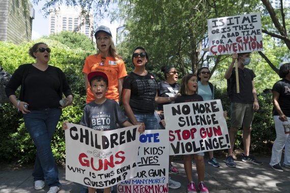 FILE - Protesters chant slogans outside the George R. Brown Convention Center to protest the National Rifle Association annual meeting in Houston, May 27, 2022. March for Our Lives and other gun control groups plan to mobilize supporters on June 11, 2022, to push Congress to require universal backgr