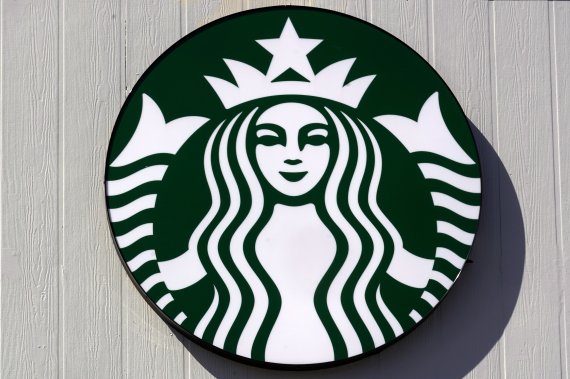 The mermaid logo on a sign outside the Starbucks coffee shop, Monday, March 14, 2022, in Londonderry, N.H. Rossann Williams, Starbucks’ North America president who's been a prominent figure in the company's push against worker unionization, is leaving the company after 17 years. (AP Photo/Charles Kr