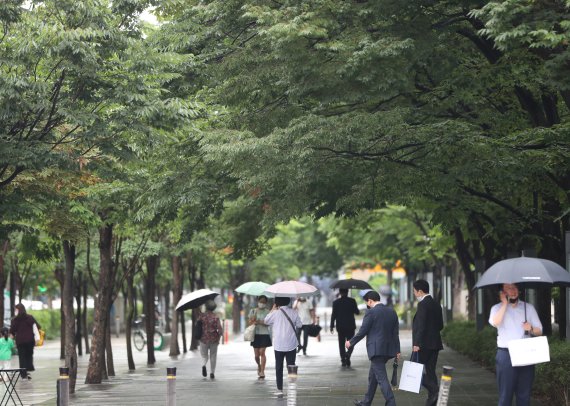 본격적인 장마철이 시작된 27일 서울 여의도역 인근에서 우산을 쓴 시민들이 이동하고 있다.사진=뉴스1