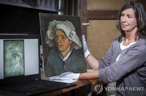 Senior Conservator Lesley Stevenson views Head of a Peasant Woman alongside an x ray image of the hidden Van Gogh self portrait. A previously unknown self-portrait of Vincent Van Gogh has been discovered behind another of the artist’s paintings. The National Galleries of Scotland said Thursday it wa