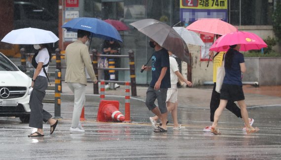 부산에 호우주의보가 내려진 18일 오전 부산도시철도 동래역 인근에서 시민들이 우산을 쓰고 발걸음을 재촉하고 있다./제공=연합뉴스