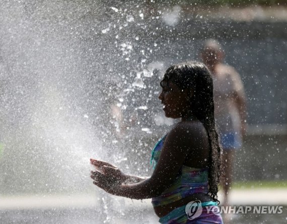 스페인 마드리드의 분수에서 더위를 식히는 시민 A girl cools off at a fountain in Madrid Rio Park during the second heatwave of the year in Madrid, Spain, July 14, 2022. REUTERS/Isabel Infantes