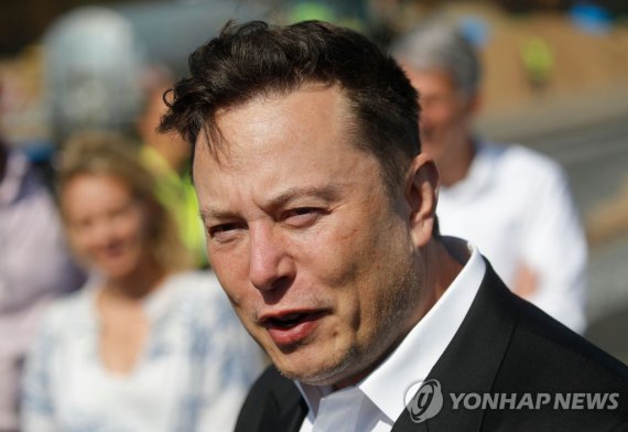 (FILES) In this file photo taken on September 3, 2020 Tesla CEO Elon Musk talks to media as he arrives to visit the construction site of the future US electric car giant Tesla, in Gruenheide near Berlin. - The court battle between Elon Musk and Twitter kicked off on July 19, 2022, as the social medi