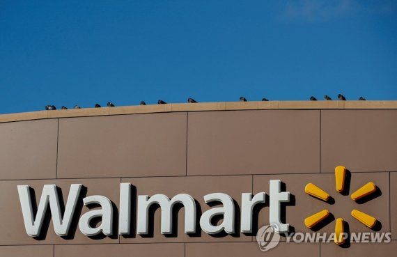 FILE PHOTO: Walmart's logo is seen outside one of its stores in Chicago, Illinois, U.S., November 20, 2018. REUTERS/Kamil Krzaczynski/File Photo