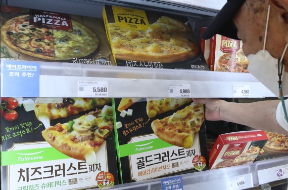 [서울=뉴시스]조수정 기자 = 식품업계가 냉동피자 시장을 주목하고 있다. 제품 제조 기술 발달과 에어프라이어 보급률이 높아지면서 전문점 수준의 맛을 집에서도 낼 수 있게 되는데다 코로나19 여파로 지속되는 사회적 거리두기 시행으로 냉동피자 시장이 더 커지는 요소로 분류된다. 6일 서울 중구 롯데마트 서울역점에서 한 시민이 피자를 고르고 있다. 2021.07.06. chocrystal@newsis.com