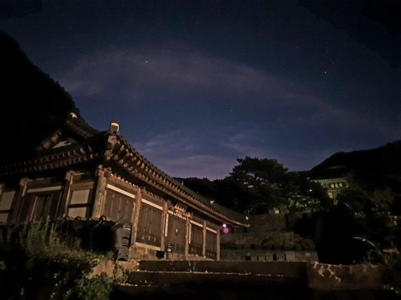 새벽의 미황사. 어스름한 우주에 파르스름한 기운이 돌고, 보석처럼 박힌 별들이 총총하다 ⓒ 뉴스1