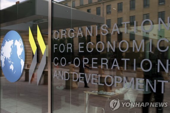 FILE - The logo at the entrance of the Organisation for Economic Co-operation and Development (OECD) headquarters in Paris, June 7, 2017. The OECD on Monday, Sept. 26, 2022 says Russia’s war in Ukraine and the lingering effects of the COVID-19 pandemic are dragging down global economic growth more t