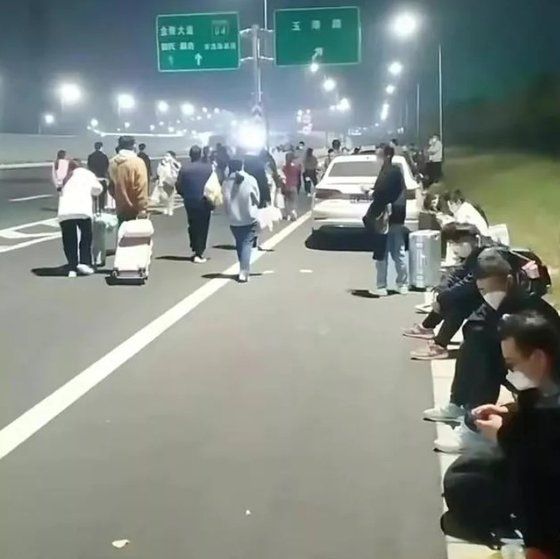 중국 허난성 정저우시 폭스콘 노동자들로 추정되는 이들이 공장을 떠나 고속도로를 걸어 귀향하는 모습. 출처=중국 진르터우탸오 캡처. 중앙일보