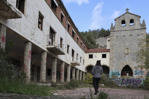 epa10296318 A person walks through the old town of Salto de Castro, Spain, 08 November 2022 (issued 09 November 2022). The town has been uninhabited for over three decades since the hydroelectric plant that was built in the 50's was shut down. The municipality of Fonfria (in Zamora province, central