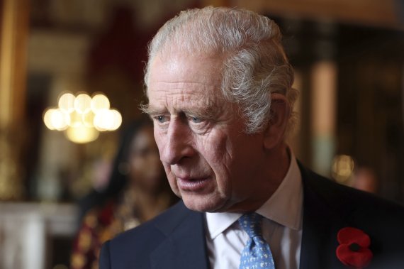 FILE - Britain's King Charles III talks with guests during a reception and ceremony commemorating the 50th anniversary of the Resettlement of British Asians from Uganda in the UK, at Buckingham Palace in London, Nov. 2, 2022. Britain will pause for a two minutes of silence on Sunday Nov. 13, 2022, t