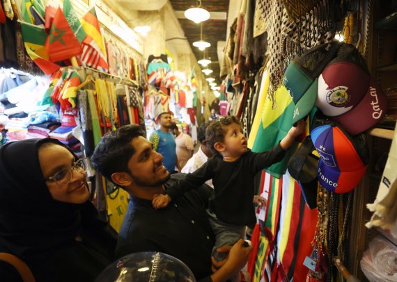 [도하(카타르)=뉴시스] 조성우 기자 = 2022 카타르 월드컵 개막을 사흘 앞둔 17일(현지시간) 오후 카타르 도하 수크 와키프 거리 한 상점에서 한 가족이 월드컵 기념품을 고르고 있다. 2022.11.18. xconfind@newsis.com