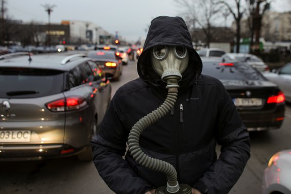 지난 2020년 2월14일(현지시간) 루마니아 부쿠레슈티에서 대기 오염에 항의하는 시위가 벌어졌다. 시위의 일환으로 한 기후 운동가가 차들 사이에서 방독면을 착용하고 있는 모습. 22.02.14 ⓒ 로이터=뉴스1 ⓒ News1 김예슬 기자