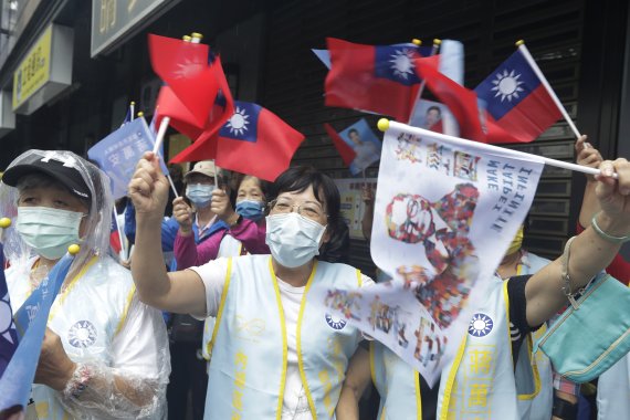 [타이베이=AP/뉴시스] 대만 국민당(KMT)의 장완안 타이베이 시장 후보 지지자들이 24일 타이베이 거리에서 유세하는 후보에게 환호하고 있다. 대만은 26일 지방 통일선거를 치른다. 2022.11.24