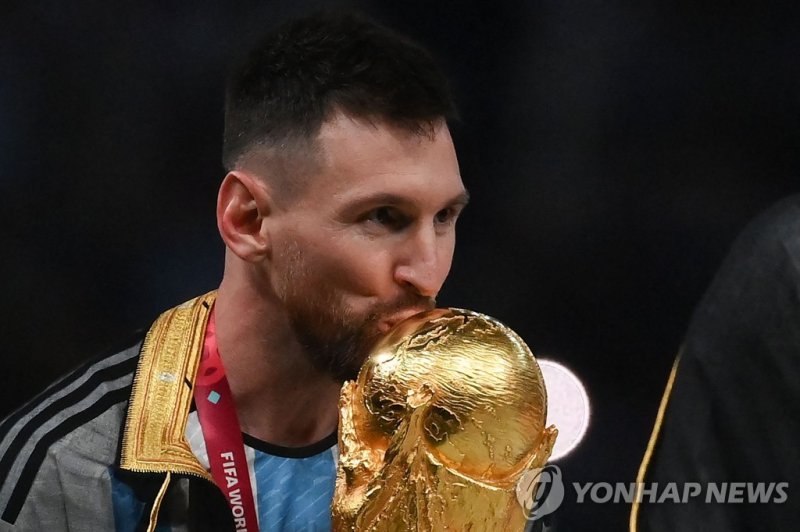 시상식에서 트로피에 입 맞추는 메시 Argentina's forward #10 Lionel Messi kisses the World Cup trophy during the Qatar 2022 World Cup trophy ceremony after the football final match between Argentina and France at Lusail Stadium in Lusail, north of Doha on December 18, 2022. - Argentina won in the penalty shoot-out. 