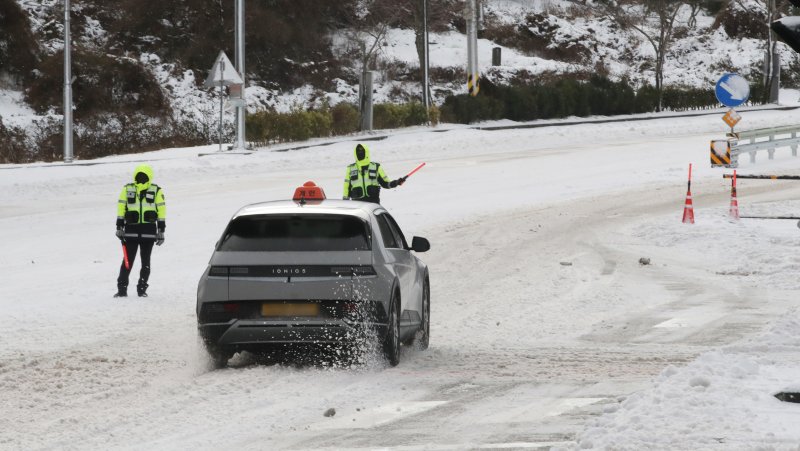 제주지역에 이틀째 대설특보가 발효 중인 23일 오전 제주시 제주대학교 사거리에서 경찰이 차량을 통제하고 있다. 2022.12.23/뉴스1 ⓒ News1 오현지 기자